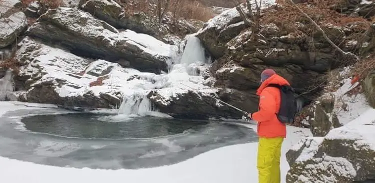 Where to find trout in winter. The water around is the waterfall is frozen.